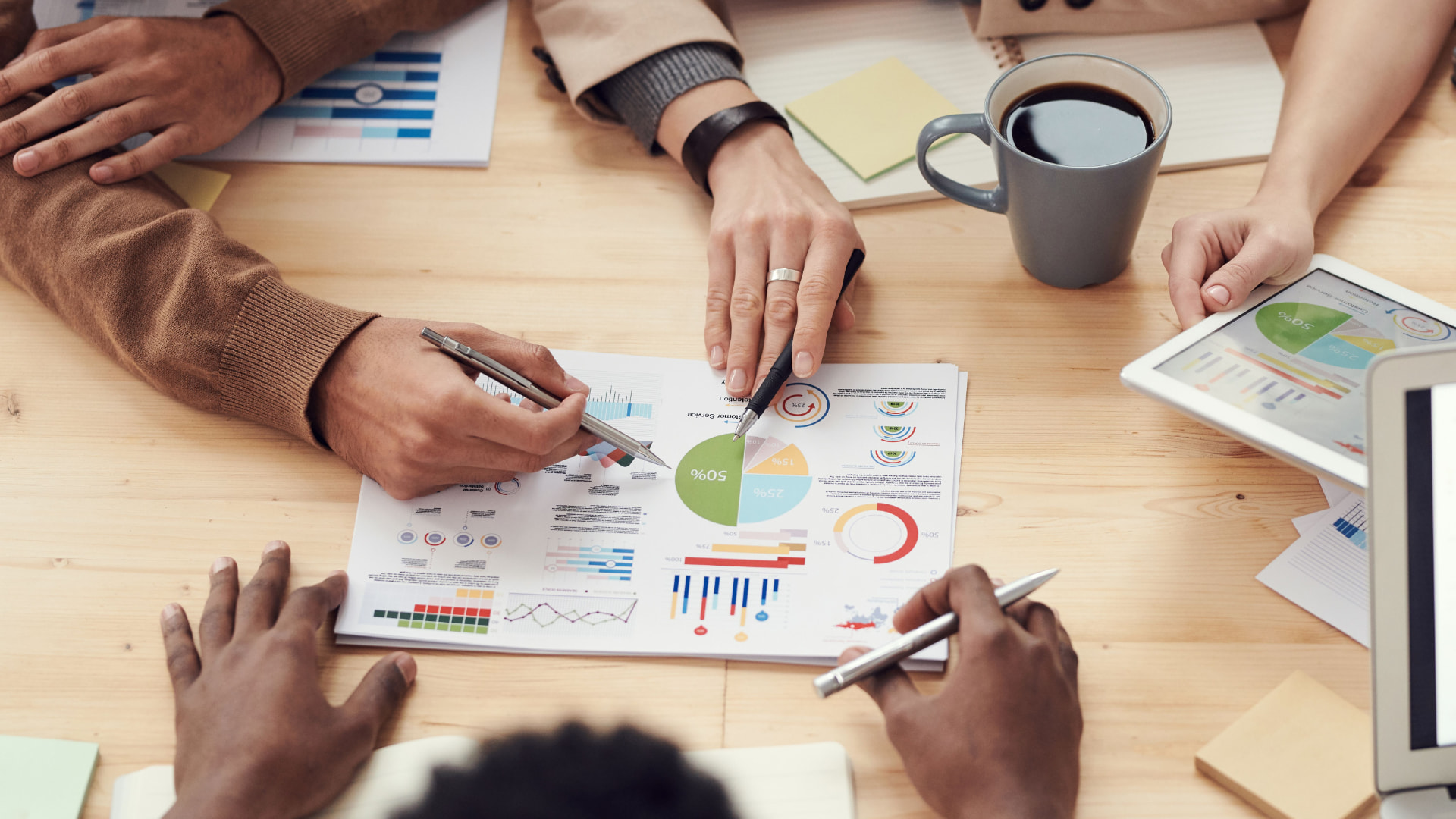 Equipo directivo analizando indicadores de negocio sobre una mesa de trabajo